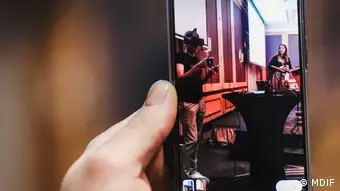 A smartphone screen shows the presentation of VR gear