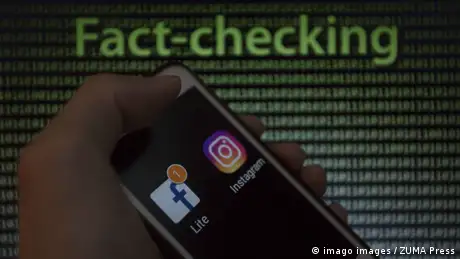 May 9 2019 Asuncion Paraguay Hand holds a smartphone displaying Facebook and Instagram logo ic