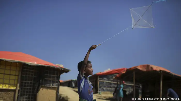 A boy flies his kite outside his family's tent in the Kutupalong refugee camp in Bangladesh (2017)